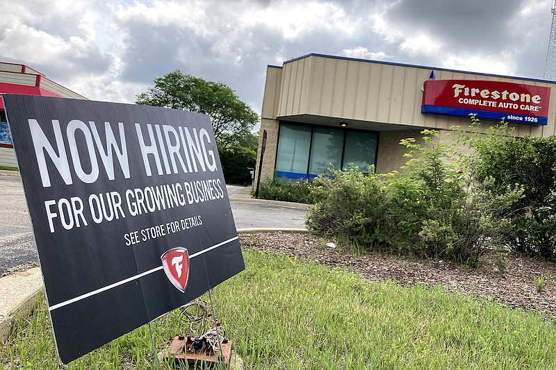 AP Photo/Nam Y. Huh / A hiring sign is displayed at Firestone Complete Auto Care store in Arlington Heights, Ill., on Wednesday. Illinois Gov. J.B. Pritzker said the state may join others in considering incentives for people to return to work.