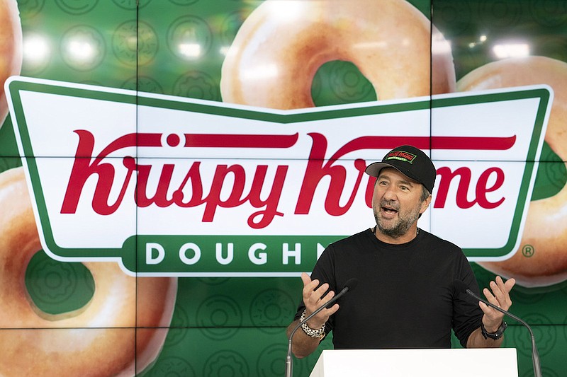 Krispy Kreme CEO Mike Tattersfield talks during the company's IPO at the Nasdaq Opening Bell, Thursday, July 1, 2021 in New York. The Charlotte, North Carolina-based company, known for its glazed doughnuts, priced its initial public offering of 29.4 million shares at $17 a piece. That's well below the $21 to $24 it was seeking. It raised $500 million and plans to use proceeds to pay down debt. (AP Photo/Mark Lennihan)