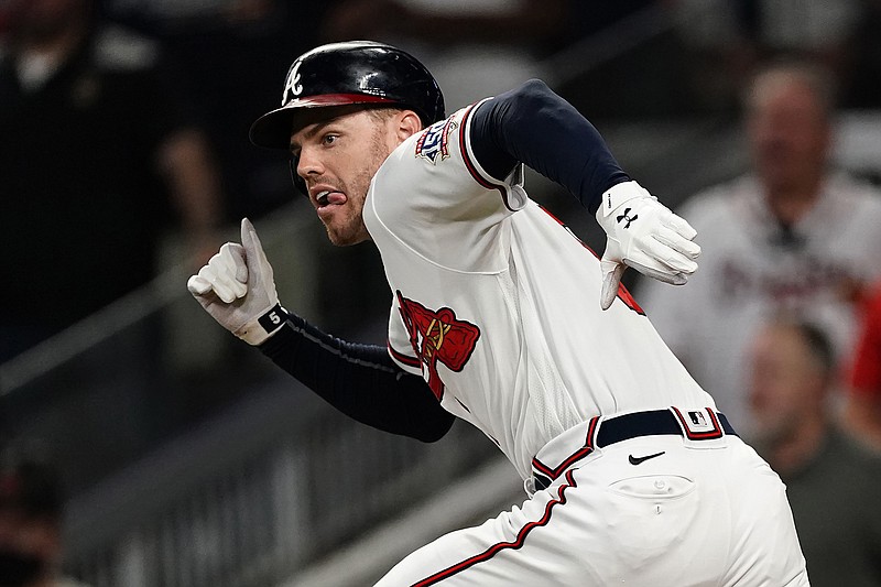 AP photo by John Bazemore / Freddie Freeman runs to first base after hitting the single that drove in the winning run during the ninth inning of the Atlanta Braves' 4-3 victory against the visiting New York Mets on Thursday night.