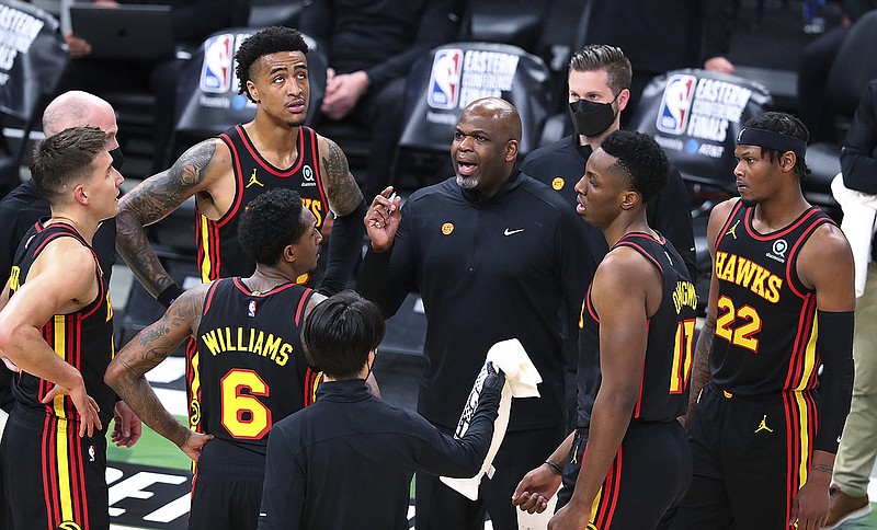 Atlanta Journal-Constitution photo by Curtis Compton via AP / Atlanta Hawks interim coach Nate McMillan talks with, from left, Bogdan Bogdanovic, John Collins, Lou Williams, Onyeka Okongwu and Cam Reddish during a timeout in Game 5 of the Eastern Conference finals against the Milwaukee Bucks on Thursday.