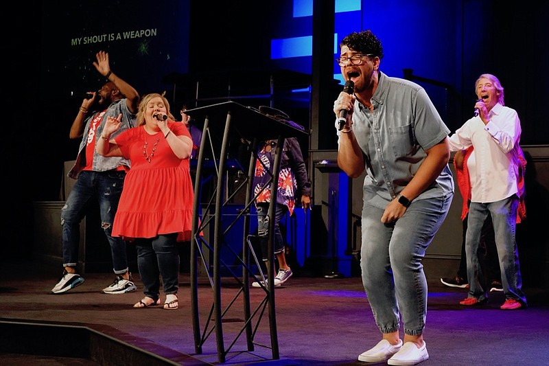 Staff photo by Wyatt Massey / Adam Aziz, executive pastor at Metro Tab Church, and members of the church music team sing during a July 4, 2021, celebration at Metro Tab.