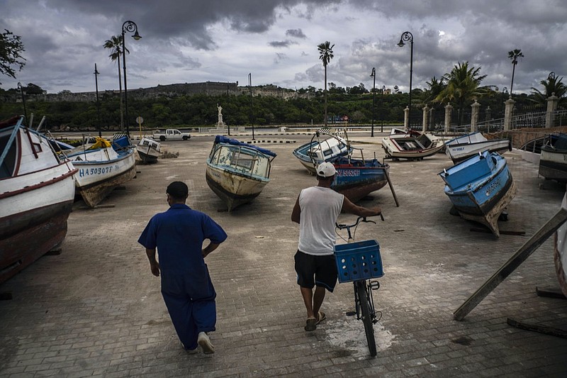 Fishermen inspect their boats after they have been taken out of the bay to avoid damage from the passage of Tropical Storm Elsa, in Havana, Cuba, Monday, July 5, 2021. (AP Photo/Ramon Espinosa)

