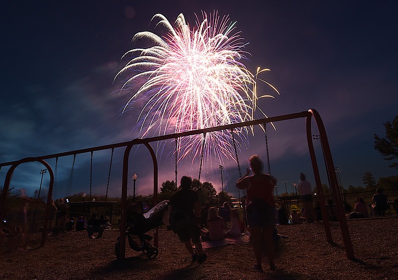 Staff Photo by Matt Hamilton / Locals watch the fireworks from swings in a playground at Heritage Point Park in Dalton, Georgia, on Sunday, July 4, 2021.