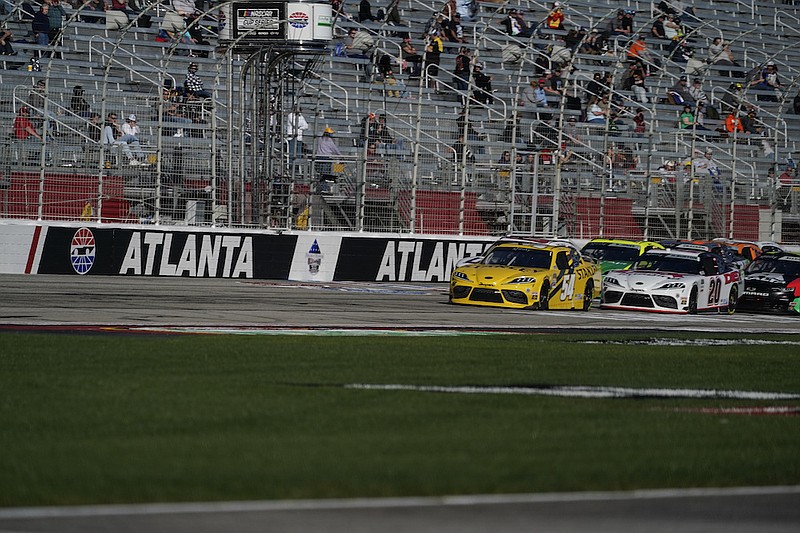 Martin Truex Jr. drives leads during a NASCAR Xfinity Series at Atlanta Motor Speedway in Hampton, Ga., in this  Saturday, March 20, 2021, file photo. After putting off the inevitable project as long as possible, Atlanta Motor Speedway officials, including track president Brandon Hutchinson, on Tuesday, July 6, announced plans to resurface the worn-out track following Sunday's NASCAR race. (AP Photo/Brynn Anderson, File)