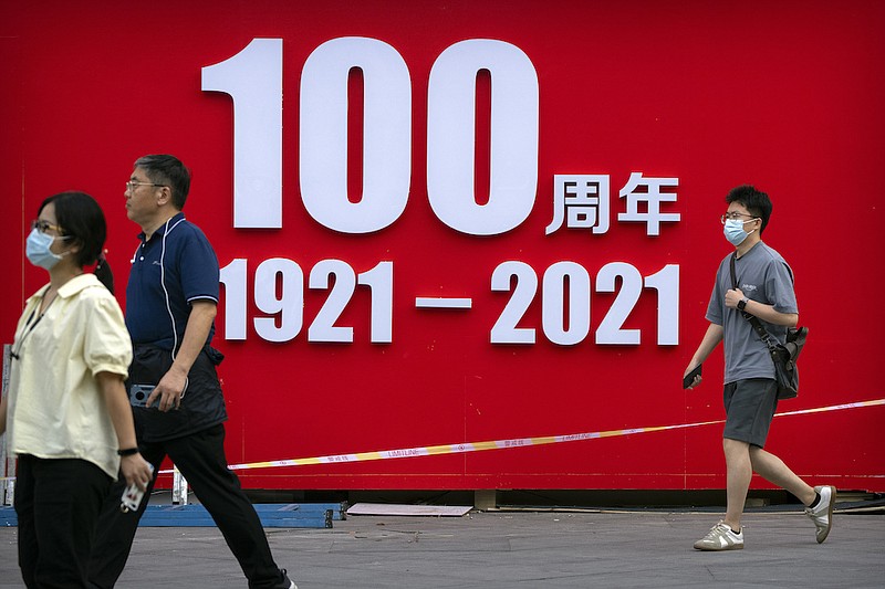 Photo by Mark Schiefelbein of The Associated Press / People walk past a partially disassembled exhibition commemorating the 100th anniversary of China's Communist Party at a shopping and office complex in Beijing on July 2, 2021. Chinese President Xi Jinping warned that anyone who tries to bully China "will face broken heads and bloodshed."