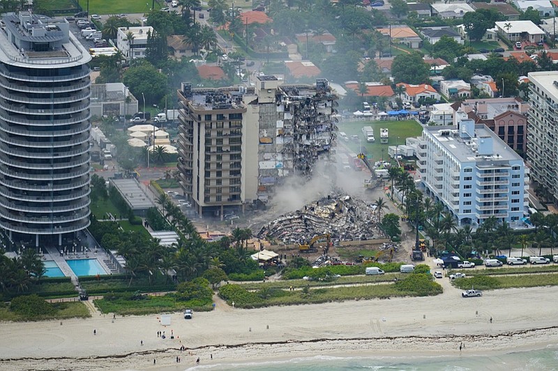 FILE - In this Friday, June 25, 2021, file photo, rescue personnel work in the rubble at the Champlain Towers South Condo, in Surfside, Fla. Even as the search continues over a week later for signs of life in the mangled debris of the fallen Champlain Towers South, the process of seeking answers about why it happened and who is to blame is already underway in Florida's legal system. (AP Photo/Gerald Herbert, File)