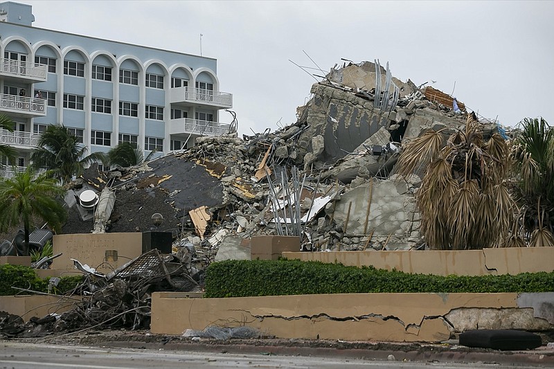 Rubble and debris of the Champlain Towers South condo can be seen Tuesday, July 6, 2021 in Surfside, Fla. Officials overseeing the search at the site of the Florida condominium collapse seem increasingly somber about the prospects for finding anyone alive. They said Tuesday that crews have detected no new signs of life in the rubble nearly two weeks after the disaster struck at the Champlain Towers South building in Surfside. (Carl Juste/Miami Herald via AP)