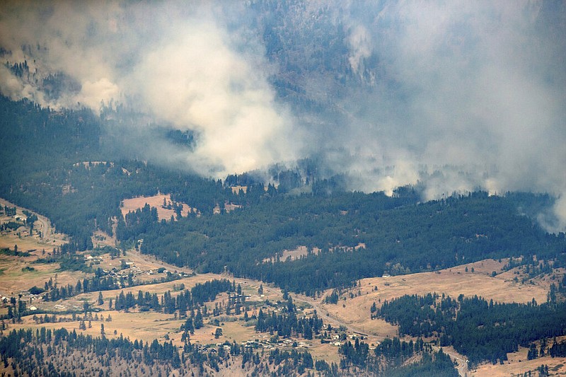  In this Thursday, July 1, 2021 file photo, a wildfire burns in the mountains north of Lytton, British Columbia, Canada, during record high temperatures. According to a study released on Wednesday, July 7, 2021, the deadly heat wave that roasted the Pacific Northwest and western Canada "was virtually impossible without human-caused climate change" which also added a few extra degrees to the record-smashing warmth. (Darryl Dyck/The Canadian Press via AP, File)