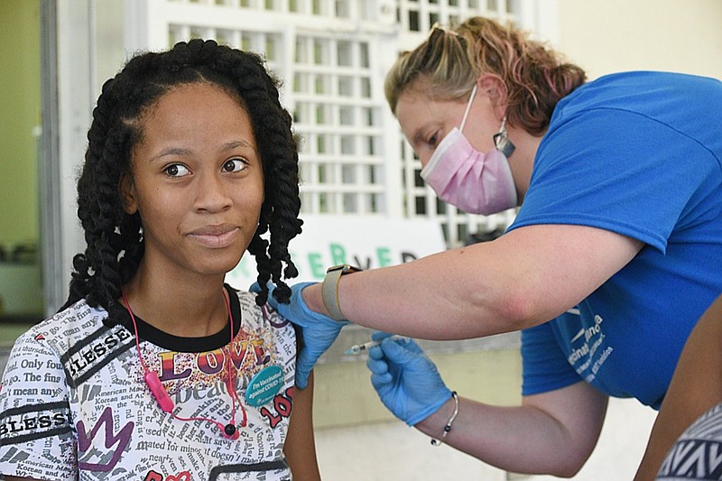 Staff Photo by Matt Hamilton / Nurse Erin Goett vaccinates Kylee Silvels, 13, at East Lake Park in Chattanooga on Saturday, July 10, 2021. Get Vaccinated Chattanooga sponsored the block party event.
