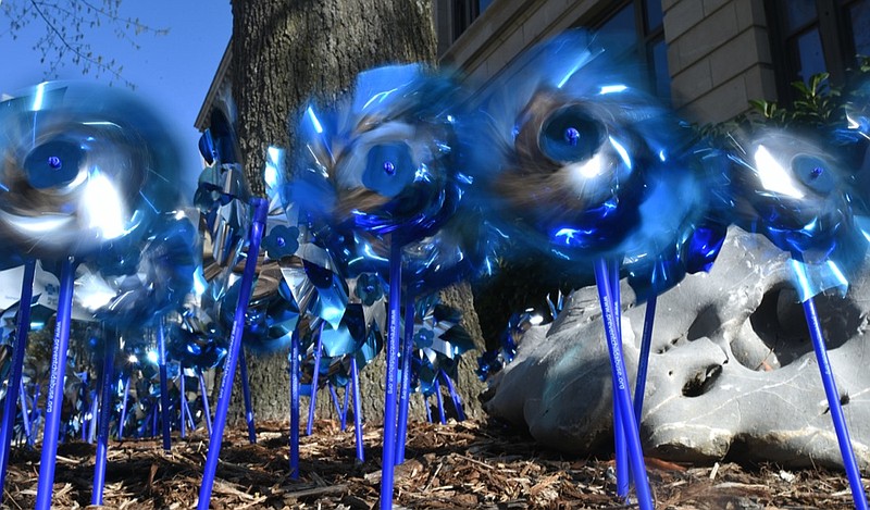 Staff Photo by Angela Lewis Foster / Blue pinwheels spin outside of Chattanooga City Hall Friday, April 7, 2017 to raise awareness of child abuse.
