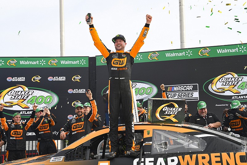 AP photo by John Amis / Kurt Busch celebrates in victory lane at Atlanta Motor Speedway after winning Sunday's NASCAR Cup Series race.