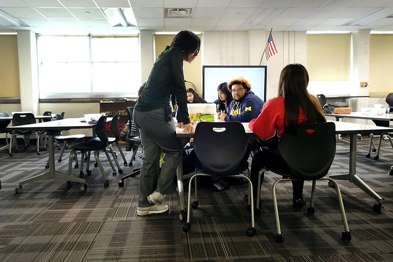 Photo by Alan Petersime for Chalkbeat / A teacher talks with students inside a classroom at Crispus Attucks High School, a public school in Indianapolis, Indiana, in April 2019.