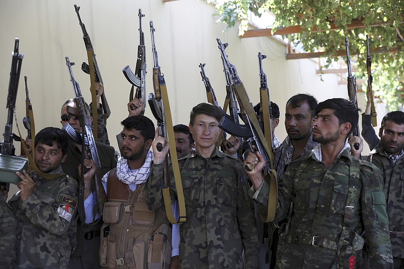 Photo by Rahmat Gul of The Associated Press / Militiamen uprising loyal to Ata Mohammad Noor, chief of Jamiat-e-Islami and a powerful northern warlord, stand guard at their office in Mazar-e-Sharif north of Kabul, Afghanistan on July 8, 2021. One of the most powerful warlords of northern Afghanistan and a key U.S. ally in the 2001 defeat of the Taliban blames a fractious Afghan government and an "irresponsible" American departure for a swift series of recent Taliban gains across the north.