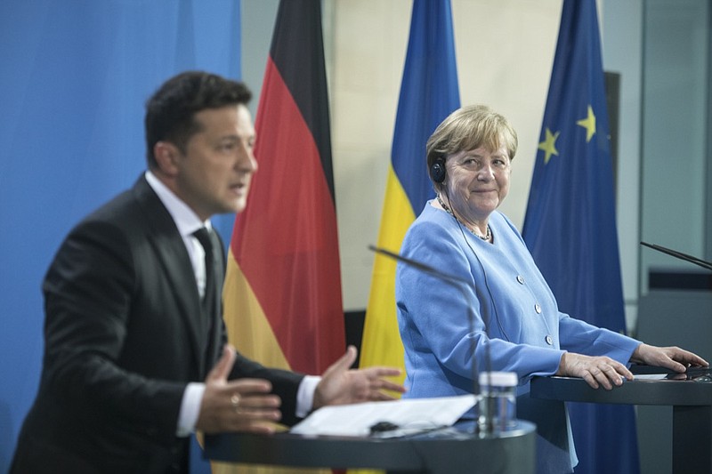 German Chancellor Angela Merkel, right, and Ukrainian President Volodymyr Zelensky give statements ahead of talks at the Chancellery in Berlin, Monday, July 12, 2021. (Stefanie Loos/Pool Photo via AP)