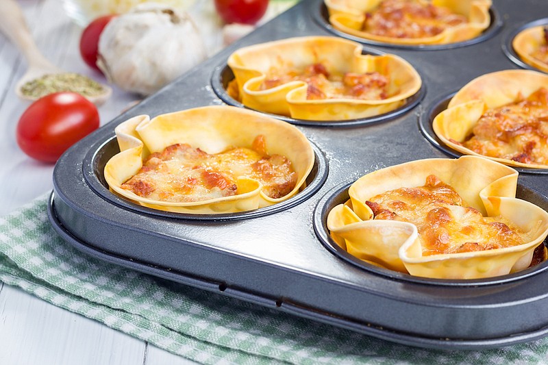 Homemade lasagna cups with minced meat, bolognese sauce topped with cheese. / Getty Images/iStock/iuliia_n