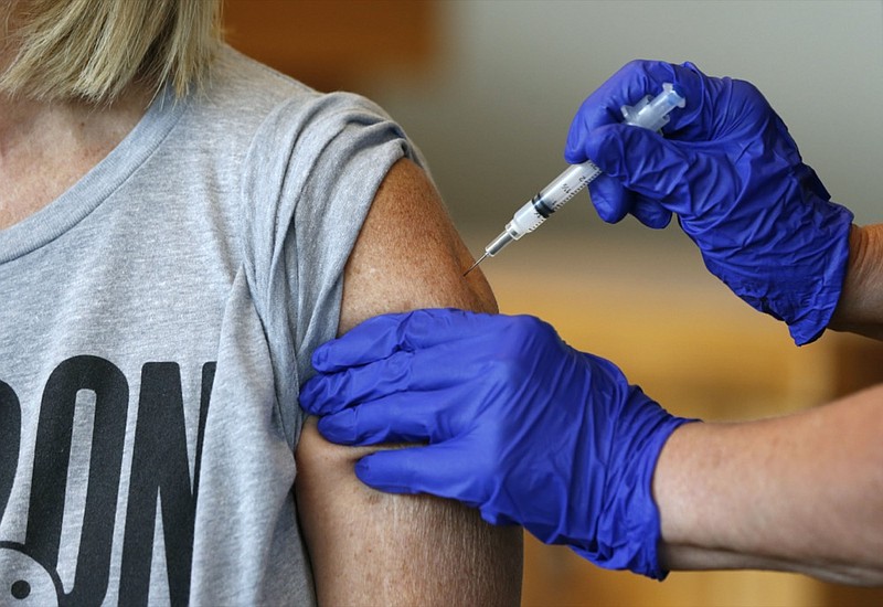 FILE - In this Monday, July 12, 2021, file photo, Karen Martin receives a COVID-19 vaccine at a vaccination clinic hosted by James River Church West Campus in conjunction with Jordan Valley Community Health Center in Springfield, Mo. (Nathan Papes/The Springfield News-Leader via AP, File)


