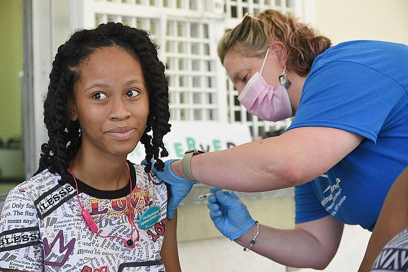 Staff Photo by Matt Hamilton / Nurse Erin Goett vaccinates Kylee Silvels, 13, at East Lake Park in Chattanooga on Saturday, July 10, 2021. Get Vaccinated Chattanooga sponsored the block party event.