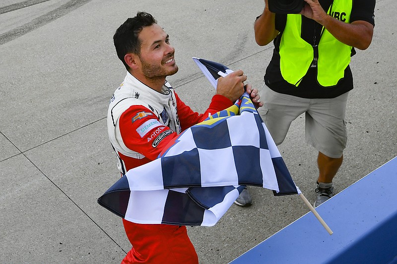 AP photo by John Amis / NASCAR driver Kyle Larson takes the checkered flag after winning a Cup Series race on June 20 at NASCAR Superspeedway in Lebanon, Tenn.