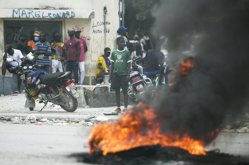 In this July 12, 2021, photo, a tire set on fire by supporters of former Senators Youri Latortue and Steven Benoit outside the courthouse in Port-au-Prince. (AP Photo/Matias Delacroix)


