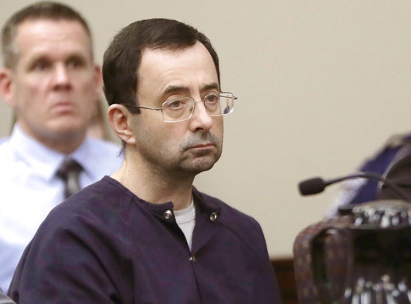 In this Jan. 24, 2018, file photo, Larry Nassar, a former doctor for USA Gymnastics and member of Michigan State's sports medicine staff, sits in court during his sentencing hearing in Lansing, Mich. The FBI made numerous serious errors in investigating allegations against former USA Gymnastics national team doctor Larry Nassar and didn't treat the case with the "utmost seriousness," the Justice Department's inspector general said Wednesday, July 24, 2021. The FBI acknowledged conduct that was "inexcusable and a discredit" to America's premier law enforcement agency. (AP Photo/Carlos Osorio, File)