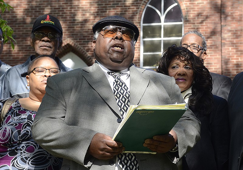 Staff file photo / Sherman Matthews, center, chair of the Unity Group, gathered with others at a 2014 news conference at the Eastdale Village Community United Methodist Church.