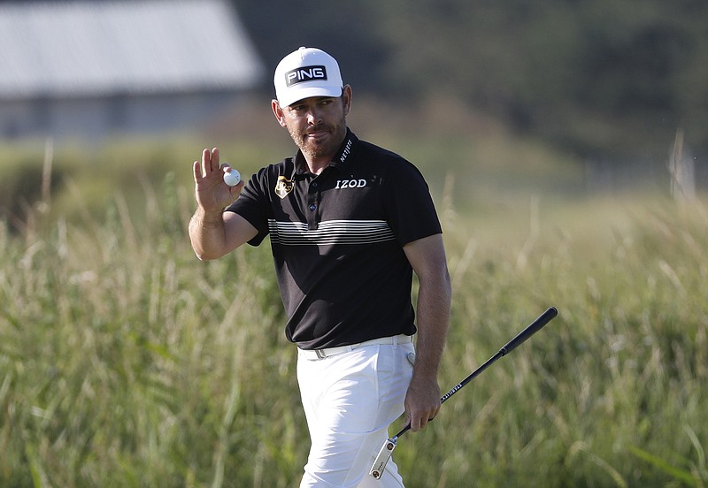 AP photo by Peter Morrison / Louis Oosthuizen acknowledges the crowd after making an eagle putt on the 14th hole at Royal St. George's Golf Club during the second round of the British Open on Friday in Sandwich, England.