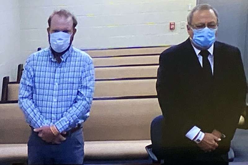 FILE - In this image made from video, Travis McMichael, left, and Greg McMichael listen to a preliminary hearing via a court video feed, Thursday, June 4, 2020, while inside the in the Glynn County jail, in Brunswick, Ga. (Glynn County Jail via AP, Pool)


