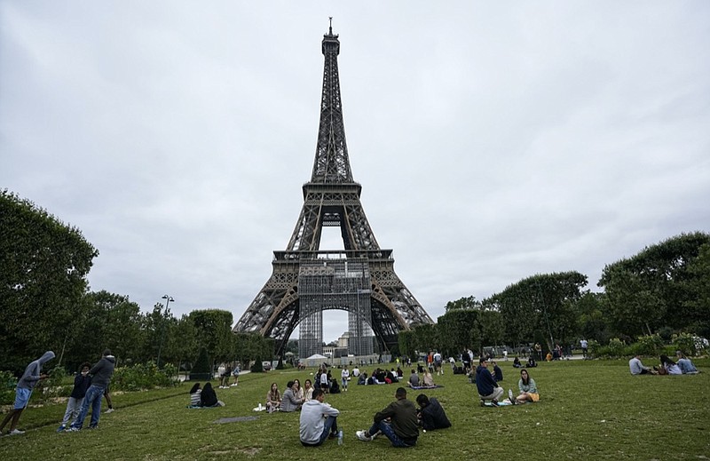 People relax at the Champ-de-Mars garden next to the Eiffel Tower in Paris, Friday, July 16, 2021. (AP Photo/Michel Euler)


