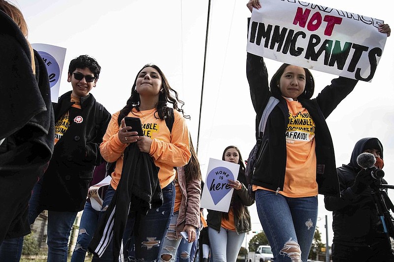 In this Tuesday, Nov. 12, 2019 file photo, Immigrant youth and advocates rally to the office of Attorney General Ken Paxton on the day of the Supreme Court's hearing on DACA in Austin, Texas. A federal judge in Texas on Friday, July 16, 2021 ordered an end to an Obama-era program that prevented the deportations of some immigrants brought into the United States as children, putting new pressure for action on President Joe Biden and Democrats who now control Congress. (Lola Gomez/Austin American-Statesman via AP, File)
