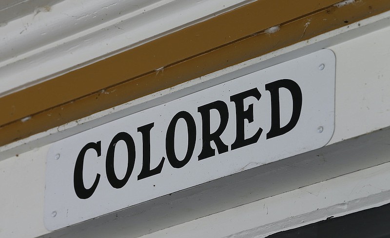 Associated Press file photo / This 2016 photo shows a sign marking the entrance to the colored area at the Montpelier Train Depot segregation exhibit in Orange, Va., after preservationists at President James Madison's Montpelier estate decided to keep the segregated waiting rooms when the structure was renovated in 2010.