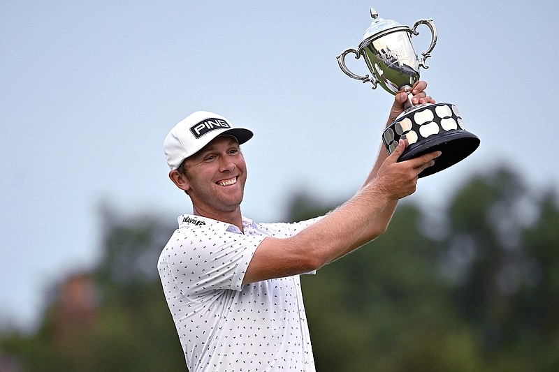 AP photo by Timothy D. Easley / Seamus Power holds up his trophy after winning the PGA Tour's Barbasol Championship on Sunday in Nicholasville, Ky.