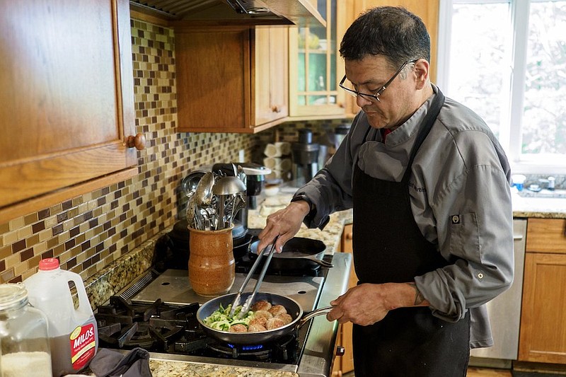 Staff file photo / Personal chef Jeffrey Martinez cooks a dish of turkey meatballs and zucchini noodles at his mother's home in Signal Mountain.
