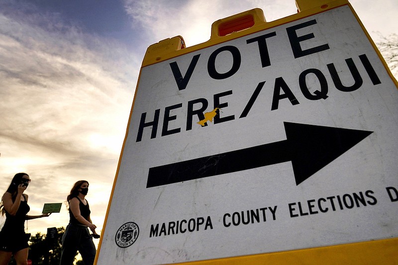 AP File Photo/Matt York / Voters deliver their ballot for the 2020 presidential election to a polling station in Tempe, Ariz.