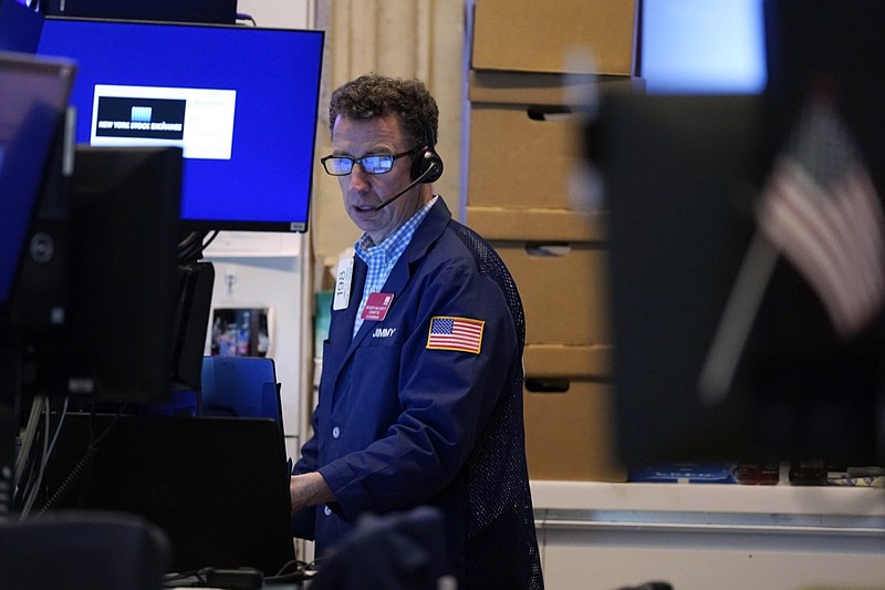 A trader works in his booth on the floor of the New York Stock Exchange, Monday, July 12, 2021. Stocks are opening broadly lower on Wall Street, echoing losses overseas, as investors become more worried about a resurgence in global infections of COVID-19. The benchmark S&P 500 was down 1.2% in the early going Monday, July 19 and Treasury yields moved lower as investors moved money into U.S. government bonds. (AP Photo/Richard Drew)

