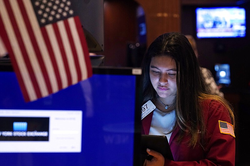 Trader Ashley Lara works on the floor of the New York Stock Exchange, Tuesday, July 20, 2021. Stocks are opening higher on Wall Street Tuesday as investors shake off a rout a day earlier brought on by concerns about the spread of a more contagious variant of COVID-19. (AP Photo/Richard Drew)