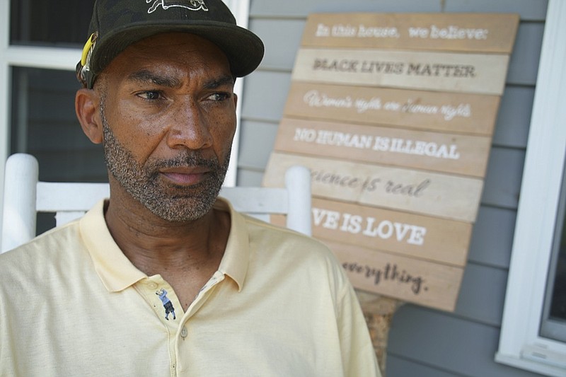 Alton Lucas sits on the porch of his home outside of Raleigh, N.C., on Friday, June 18, 2021. As a teenager, Alton Lucas believed basketball or music would pluck him out of North Carolina and take him around the world. In the late 1980s, he was already the right-hand man to his musically inclined best friend, Youtha Anthony Fowler, who many hip hop and R&B heads know today as DJ Nabs. (AP Photo/Allen G. Breed)