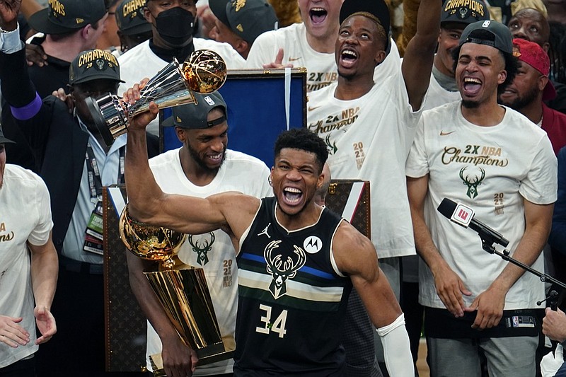 Milwaukee Bucks forward Giannis Antetokounmpo (34) holds the finals MVP trophy after the Bucks defeated the Phoenix Suns in Game 6 of basketball's NBA Finals in Milwaukee, Tuesday, July 20, 2021. The Bucks won 105-98. (AP Photo/Paul Sancya)