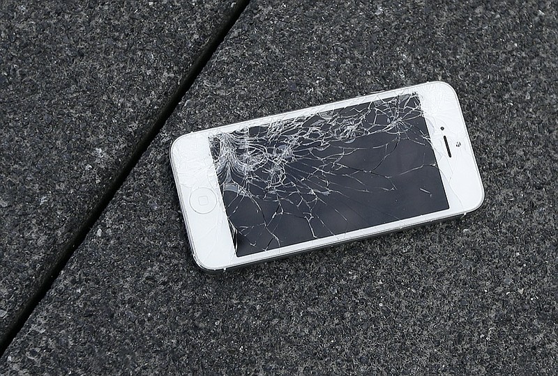 FILE - This Aug. 26, 2015 photo shows an Apple iPhone with a cracked screen after a drop test from the DropBot, a robot used to measure the sustainability of a phone to dropping, at the offices of SquareTrade in San Francisco. (AP Photo/Ben Margot, File)



