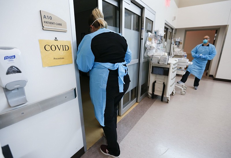 FILE - In this July 16, 2021 file photo, nurses and doctors in the CoxHealth Emergency Department in Springfield, Mo., don personal protective equipment to treat patients with COVID-19. (Nathan Papes/The Springfield News-Leader via AP)


