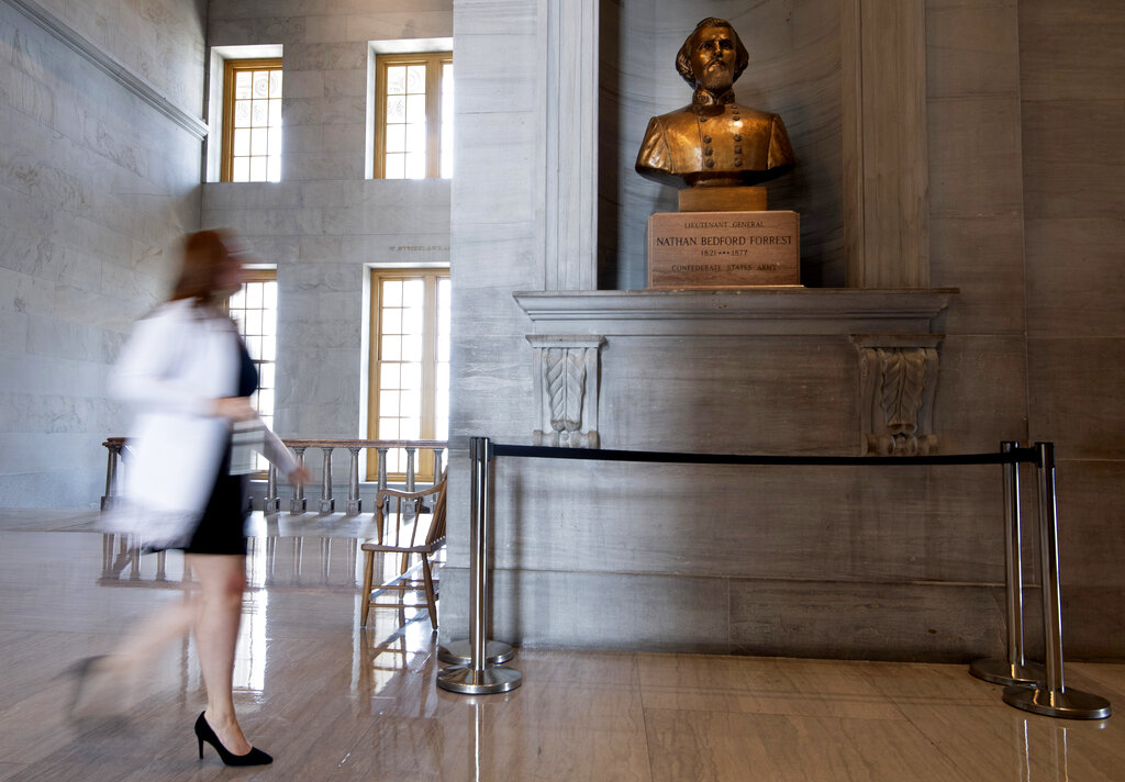 A capitol employee walks past a bust of Confederate general and early Ku Klux Klan leader Nathan Bedford Forrest at the State Capitol Thursday, July 22, 2021, in Nashville, Tenn. A decadeslong effort to remove the bust from the Tennessee Capitol cleared its final hurdle Thursday, with state leaders approving the final vote needed to allow the statue to be relocated to a museum. (George Walker IV/The Tennessean via AP)