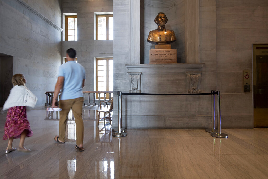 Visitors walk past a bust of Confederate general and early Ku Klux Klan leader Nathan Bedford Forrest at the State Capitol Thursday, July 22, 2021, in Nashville, Tenn. A decadeslong effort to remove the bust from the Tennessee Capitol cleared its final hurdle Thursday, with state leaders approving the final vote needed to allow the statue to be relocated to a museum. (George Walker IV/The Tennessean via AP)