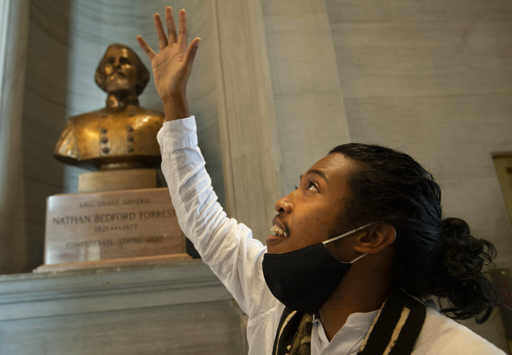 Activist Justin Jones gives praise to God in front of the Nathan Bedford Forrest bust in the State Capitol Thursday, July 22, 2021 in Nashville, Tenn., after the removal of the bust was approved by by the State Building Commission. Jones led protests over the summer of 2020 to have the bust removed. A decadeslong effort to remove the bust from the Tennessee Capitol cleared its final hurdle Thursday, with state leaders approving the final vote needed to allow the statue to be relocated to a museum. (George Walker IV/The Tennessean via AP)