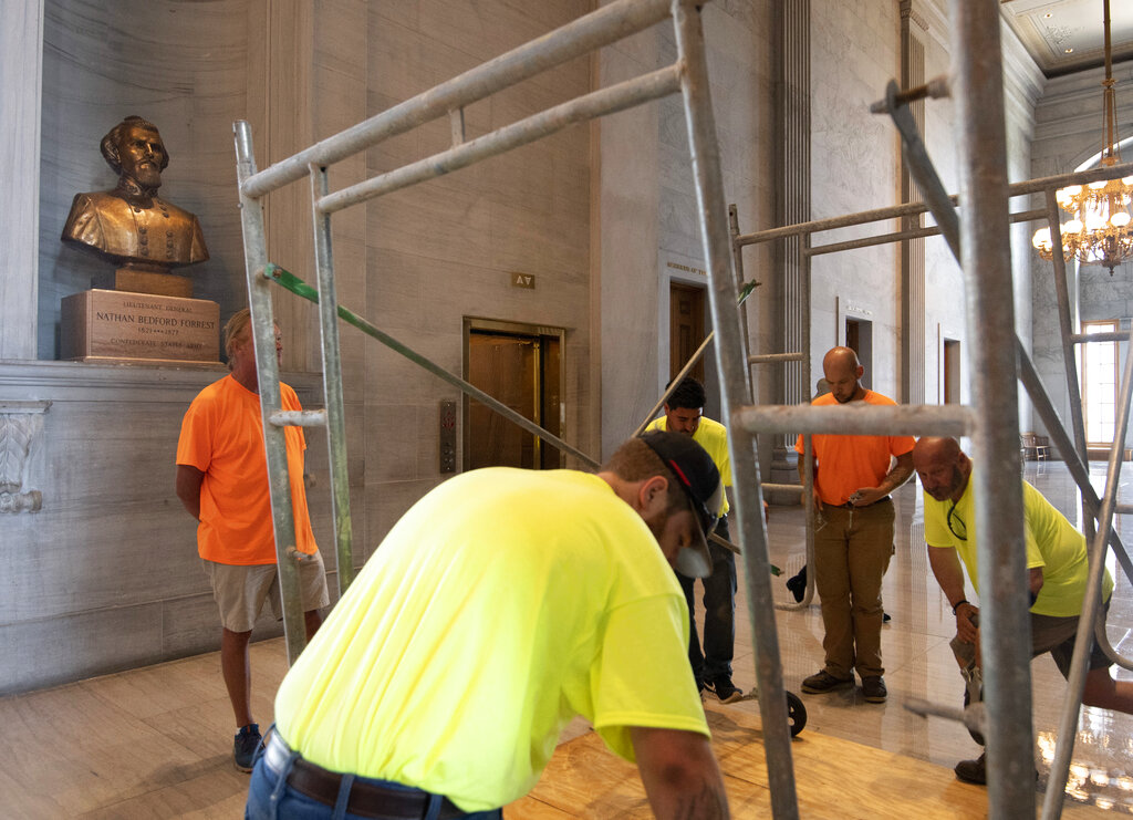 Workers prepare scaffolding in front of a bust of Confederate general and early Ku Klux Klan leader Nathan Bedford Forrest at the State Capitol Thursday, July 22, 2021, in Nashville, Tenn. A decadeslong effort to remove the bust from the Tennessee Capitol cleared its final hurdle Thursday, with state leaders approving the final vote needed to allow the statue to be relocated to a museum. (George Walker IV/The Tennessean via AP)