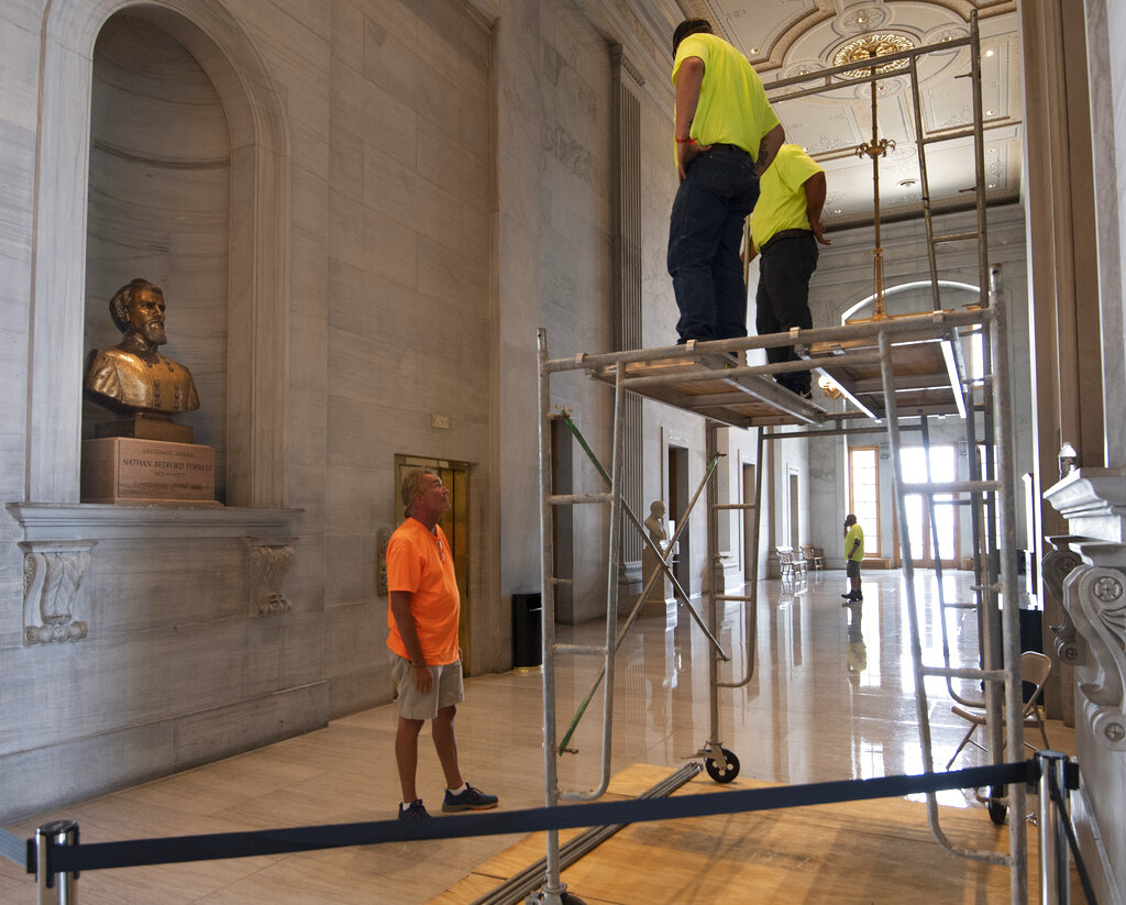Workers prepare scaffolding in front of a bust of Confederate general and early Ku Klux Klan leader Nathan Bedford Forrest at the State Capitol, Thursday, July 22, 2021, in Nashville, Tenn. A decades-long effort to remove the bust from the Tennessee Capitol cleared its final hurdle Thursday, with state leaders approving the final vote needed to allow the statue to be relocated to a museum. (George Walker IV/The Tennessean via AP)