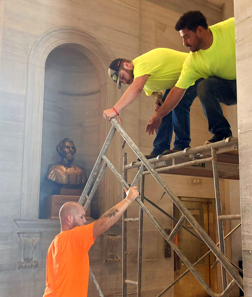 Workers prepare scaffolding in front of a bust of Confederate general and early Ku Klux Klan leader Nathan Bedford Forrest at the State Capitol, Thursday, July 22, 2021, in Nashville, Tenn. A decades-long effort to remove the bust from the Tennessee Capitol cleared its final hurdle Thursday, with state leaders approving the final vote needed to allow the statue to be relocated to a museum. (AP Photo/Kimberlee Kruesi)