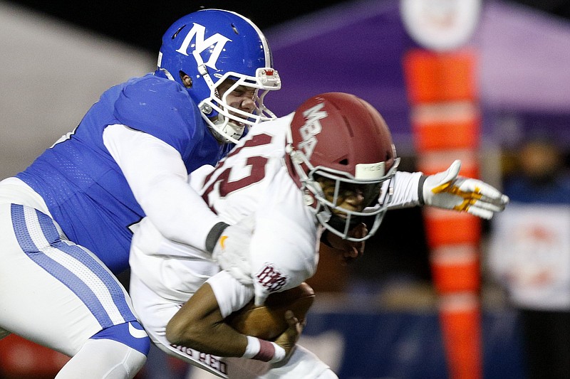 Staff photo by C.B. Schmelter / McCallie's James Howard (20) sacks MBA's Marcel Reed (12) for an 8-yard loss during the Division II-AAA BlueCross Bowl state championship at Tennessee Technological University's Tucker Stadium on Thursday, Dec. 5, 2019 in Cookeville, Tenn.