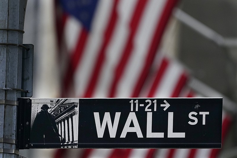 FILE - In this Nov. 23, 2020 file photo, a street sign is displayed at the New York Stock Exchange in New York. Stocks are off to a sluggish start on Wall Street as investors look over a surprise increase in claims for unemployment benefits and mixed news on corporate earnings. The S&P 500 was wavering between small gains and losses in the first few minutes of trading Thursday, July 22, 2021. (AP Photo/Seth Wenig, File)