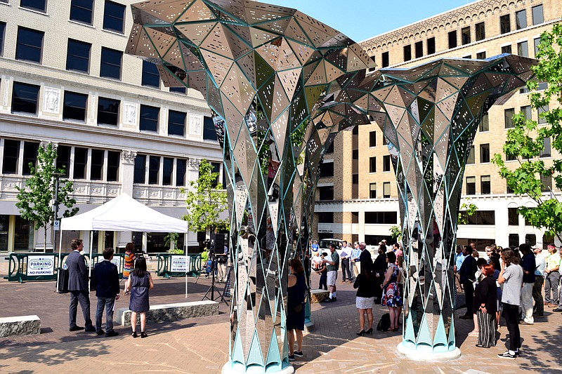 Staff Photo by Robin Rudd / People gather for the opening of Patten Square, as the sculpture, "Radiance" dominates the scene. Patten Parkway, now known as Patten Square, has received a dramatic makeover including a new street layout and art installation. A ribbon-cutting officially opened the renovation on July 23, 2021.