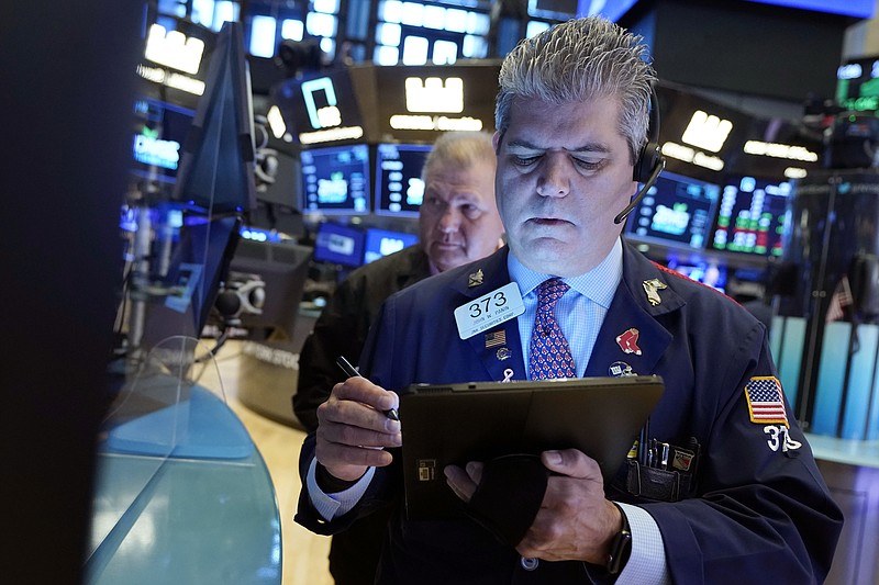Trader John Panin, foreground, works on the floor of the New York Stock Exchange, Friday, July 23, 2021. Stocks rose in early trading on Wall Street Friday and put the major indexes on track for a strong finish in a week that opened with a stumble. (AP Photo/Richard Drew)
