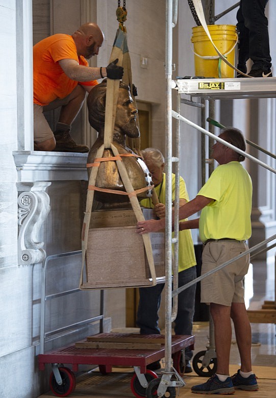 The Nathan Bedford Forrest bust is removed from the State Capitol by workers Friday, July 23, 2021, in Nashville, Tenn. The State Building Commission on Thursday gave approval for the relocation of the Forrest bust to the Tennessee State Museum, a final step in a process that has taken more than a year since Gov. Bill Lee first said it was time for the statue to be moved. (George Walker IV /The Tennessean via AP)